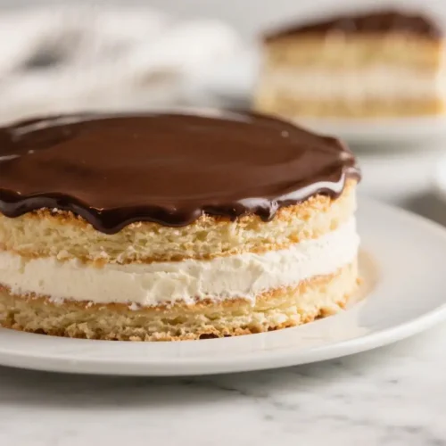 The Best Homemade Boston Cream Pie Recipe (Wicked Good!) - Classic, Creamy, and Easy 2 Boston cream pie with vanilla custard filling and glossy chocolate ganache topping