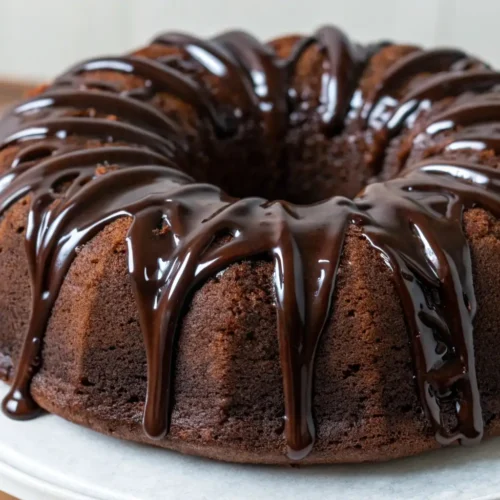 Moist chocolate sour cream Bundt cake with glossy chocolate glaze on top